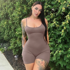 Detail of brown backless bodycon romper with straps and pleated texture in outdoor setting