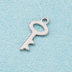 Macro shot of minimalist silver stainless steel key pendant with polished wave cut design