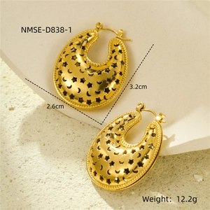 Detail view of U-shaped gold earrings with star and moon cutouts and 3.2cm height dimension