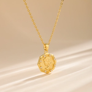 18k gold plated hexagon coin necklace with princess relief and shimmering zircon detail