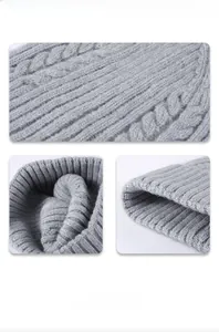 Macro shot of gray cable knit beanie showing thick texture and ribbed fold details