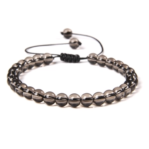 Detail of 6mm stone bead bracelet featuring adjustable black braided cord and smooth beads