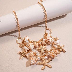 Detail of golden double-layer necklace with starfish shells and imitation pearls
