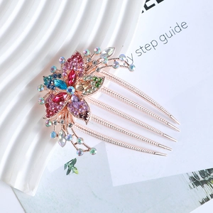 Detailed close-up of rose gold floral hair comb featuring multi-color sparkling rhinestones