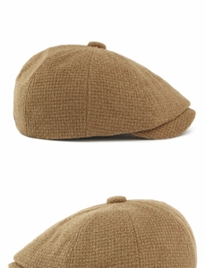 Detailed view of the brown wool blend newsboy cap showing thick woven texture and button top