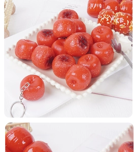Detailed view of realistic PVC hawthorn keychain accessory on a white ceramic plate
