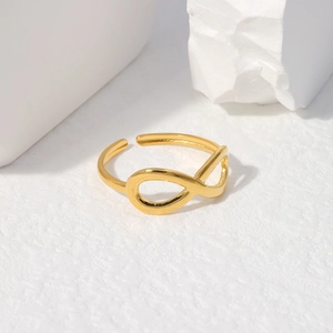 Detailed close-up of golden infinity symbol ring with an adjustable open design