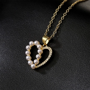 Luxury 18K gold plated heart pendant necklace with zircon and pearl on black background