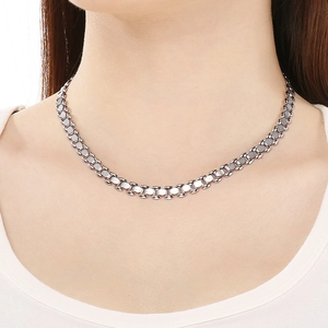 Close-up of silver steel watchband chain necklace worn on neck with oval links