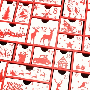 Close-up of a wooden Christmas advent calendar with white drawers and festive red numbers