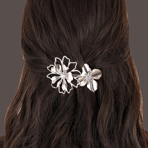 Silver hollow flower hair clip with rhinestones worn on brunette hair back view