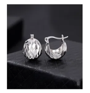Detailed macro view of S925 sterling silver hoop earrings with laser CNC diamond pattern
