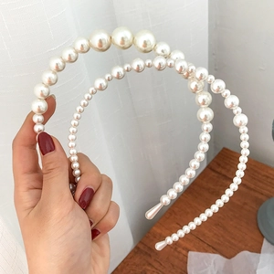Three-piece handmade pearl headbands with glossy cream pearls on elegant alloy bases
