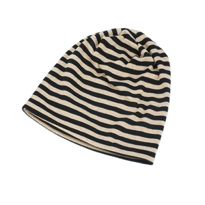 Detail of black and beige striped cotton slouchy beanie with soft knit texture