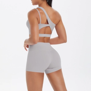 Rear view of light gray one-shoulder sports bra with geometric hollow back and shorts
