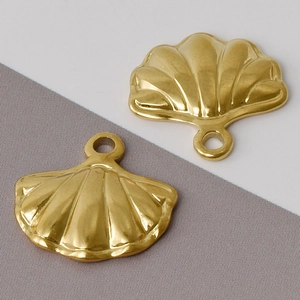 Detail of two gold scallop shell pendants in 304 stainless steel for DIY jewelry