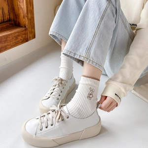 Women white cotton crew socks with rabbit embroidery paired with casual chunky sneakers