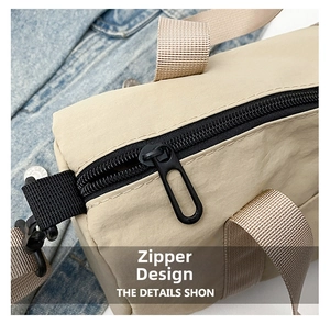 Close-up of durable black zipper and metal puller on khaki nylon leisure tote bag