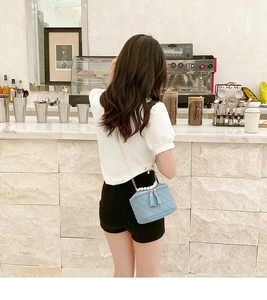 Quilted light blue square crossbody bag with pearl handle and metal chain strap detail