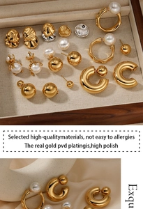 Macro detail of gold PVD plated stainless steel earrings with premium faux pearls