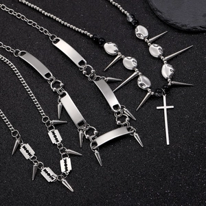 Gothic punk stainless steel necklaces with cross and spike pendants on black background