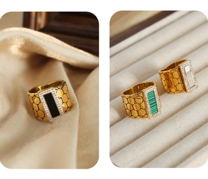 Detail of gold-plated titanium ring featuring honeycomb texture and rectangular crystal inlay