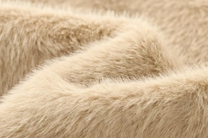 Close-up detail showing the fluffy texture and soft fibers of the beige faux fur jacket