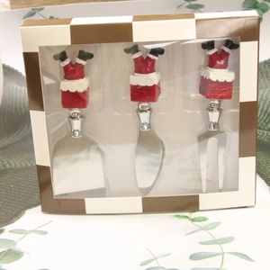 Detail of 3-piece Santa in chimney cheese knife set in a checkered gift box