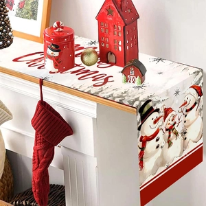 Christmas snowman table runner on a fireplace mantel with festive holiday decorations