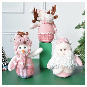 Detailed view of pink plush Christmas ornaments set featuring Santa, elk, and snowman