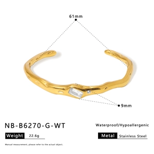 Detail of irregular gold stainless steel bangle with rectangular white stone and dimensions