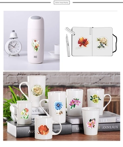 Detail view of colorful floral stickers used on water bottles and stationery journals