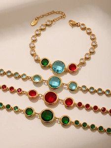 Close-up of gold plated stainless steel bracelets with vibrant colored glass stones
