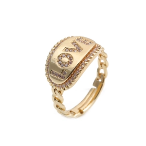 Detail of gold LOVE ring with shimmering zircon border and chain link adjustable band