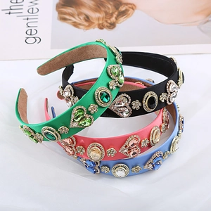 Detailed view of luxury baroque headbands featuring heart-shaped gems and gold metal flowers