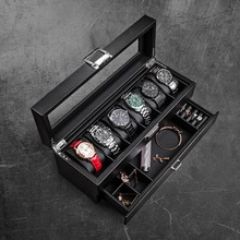 Macro detail of a double-layer black jewelry box with watch slots and accessory drawer