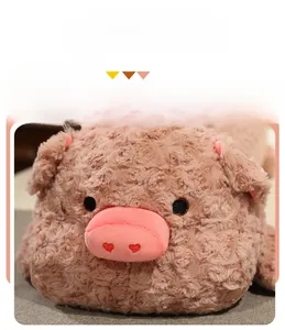 Detailed close-up of soft pink plush pig toy with heart embroidery and rose velvet fabric