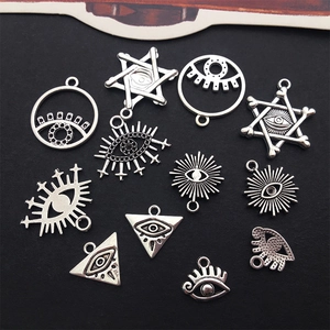 Detailed close-up of various silver alloy Eye of Horus charms for DIY jewelry making