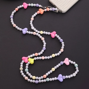 Close-up of pearl phone strap with colorful heart and geometric acrylic beads