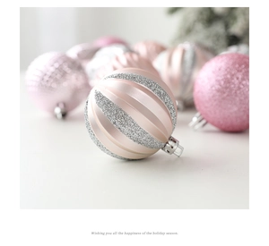 Detailed view of pink and silver 6cm Christmas baubles with glitter and stripes
