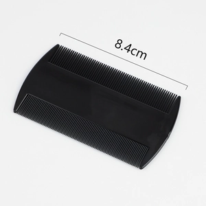 Detailed macro view of an 8.4cm black double-sided fine-tooth pet flea comb with high density
