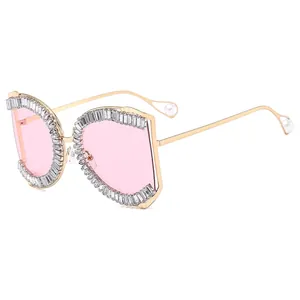 Chic oversized gold metal sunglasses with pink lenses and rhinestone-encrusted rims