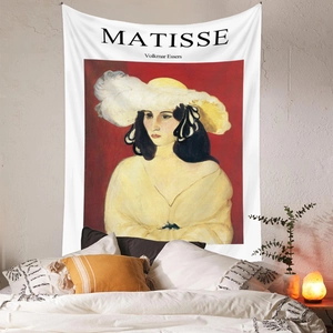 Detail of Matisse art tapestry hanging on a bedroom wall with cozy home decor elements
