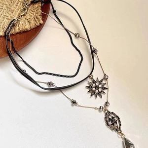 Bohemian multilayer necklace with star and teardrop pendants on gold chain and cord