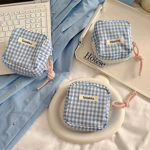 Close-up of blue gingham canvas mini storage bags with pink zip cords and Sozakka labels