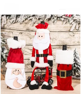 Detail of red velvet and white faux fur Christmas wine bottle covers with Santa embroidery