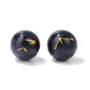 Macro detail of 10mm blue goldstone beads with engraved golden zodiac signs for DIY jewelry