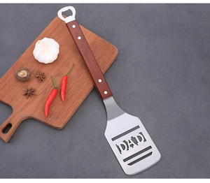 Stainless steel BBQ grill spatula with wooden handle and bottle opener, DAD cutout design.