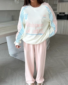 Detail of white, pink, and blue color-block sweatshirt with Whispers of attire text