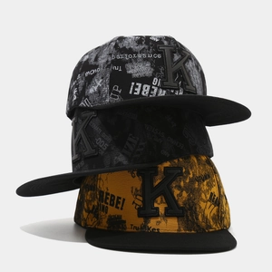 Detailed close-up of three hip-hop snapback hats with 3D letter K embroidery and graffiti